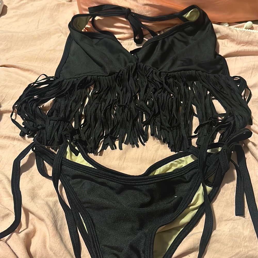 Small black two piece bathing suit with fringe